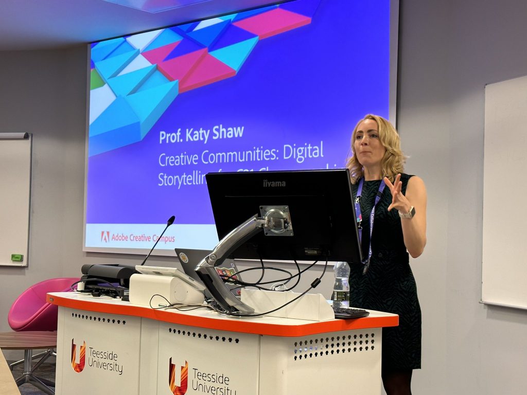 Prof Katy Shaw stands at a lectern during the conference